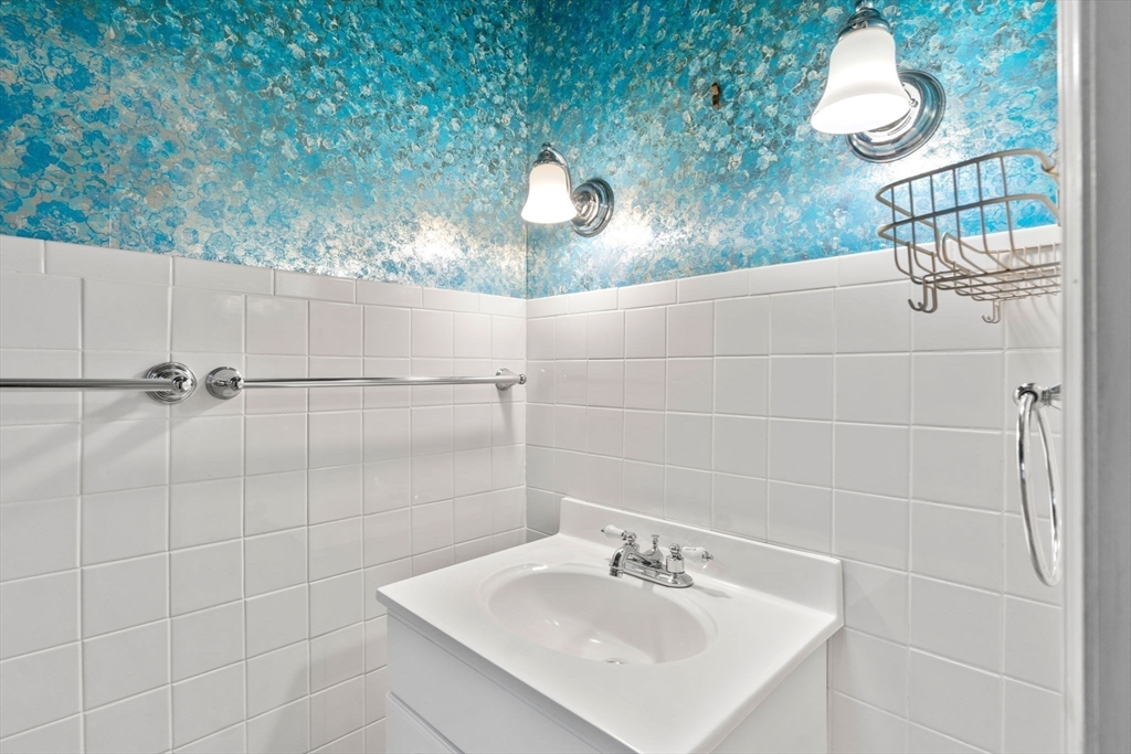 187 Clark Road Brookline, MA 02445 - Photo 29 of 40 a bathroom with a sink and mirror