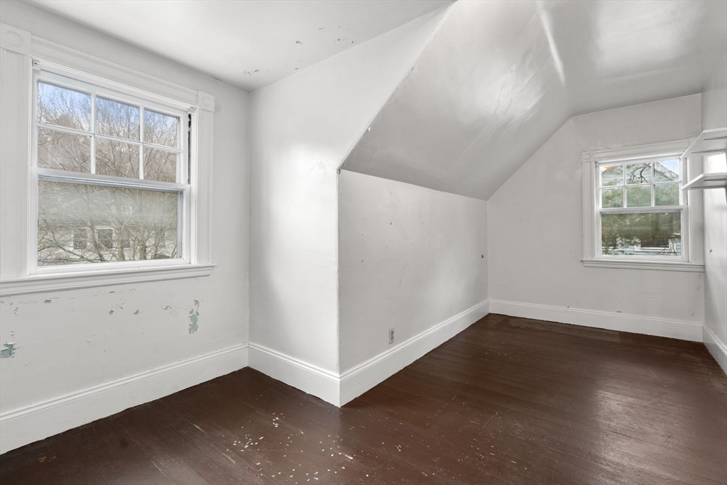 187 Clark Road Brookline, MA 02445 - Photo 3 of 40 an empty room with wooden floor and windows