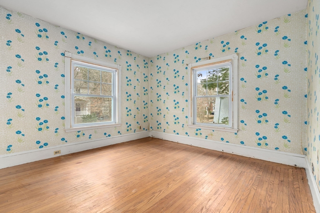 187 Clark Road Brookline, MA 02445 - Photo 33 of 40 a view of an empty room with window and wooden floor