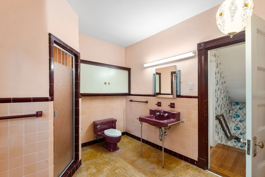 187 Clark Road Brookline, MA 02445 - Photo 34 of 40 a bathroom with a sink and a mirror