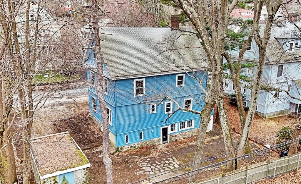 187 Clark Road Brookline, MA 02445 - Photo 7 of 40 front view of a house with a bench