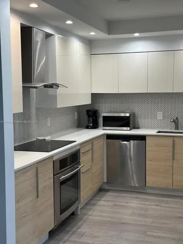 a living room with a floor to ceiling window and a flat screen tv