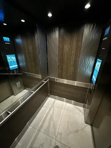 a kitchen with stainless steel appliances a sink cabinets and wooden floor