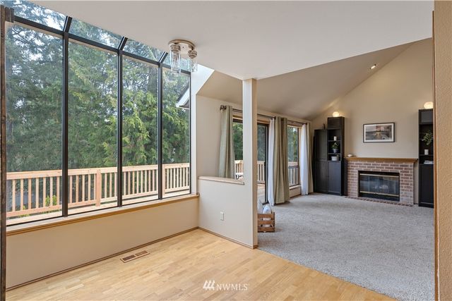 a view of an empty room with a fireplace and a window