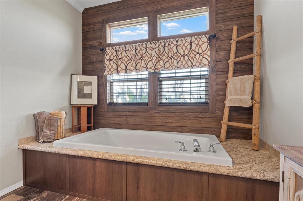 3449 Bluhm Road West, TX 76691 - Photo 20 of 40 a bathroom with a granite countertop sink and a bathtub