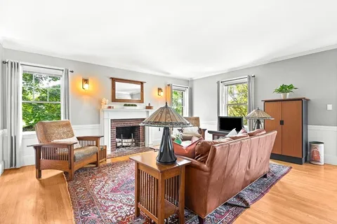 a living room with furniture fireplace and window