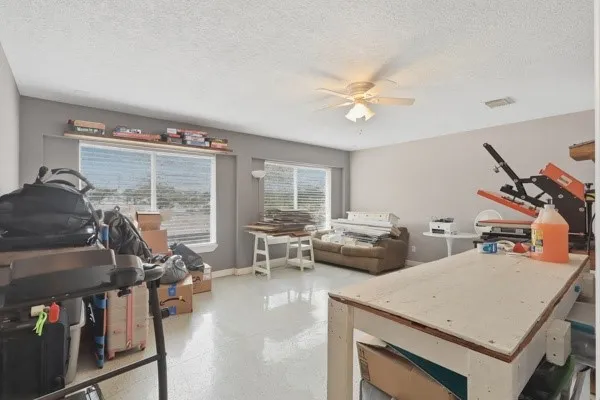 a living room with furniture a flat screen tv and a large window