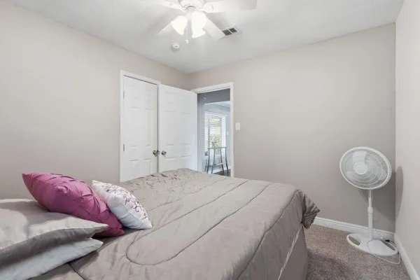 a bedroom with a bed and chandelier