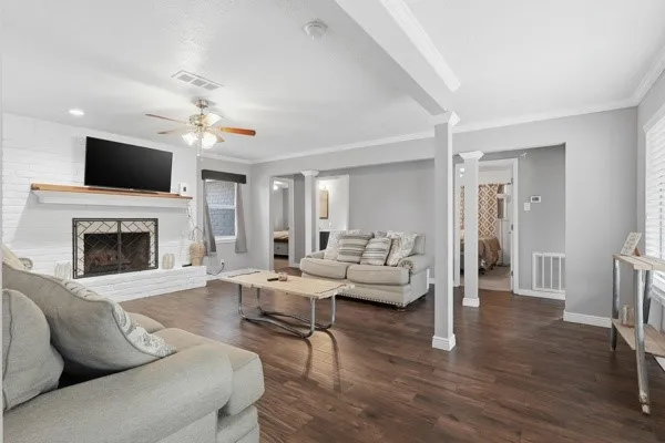 a living room with furniture a flat screen tv and a fireplace