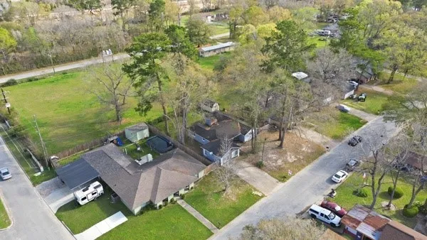 an aerial view of a house with a yard