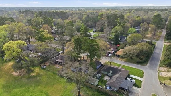 an aerial view of a house with a yard