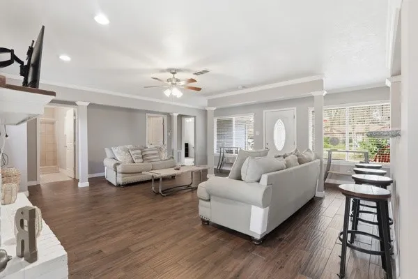 a living room with furniture and wooden floor