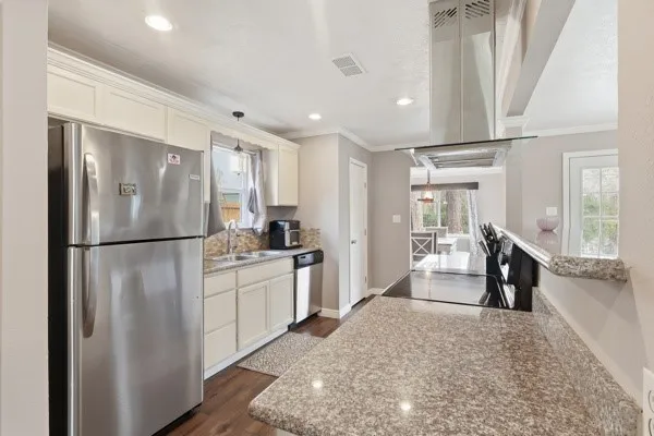 a kitchen with a refrigerator and a sink