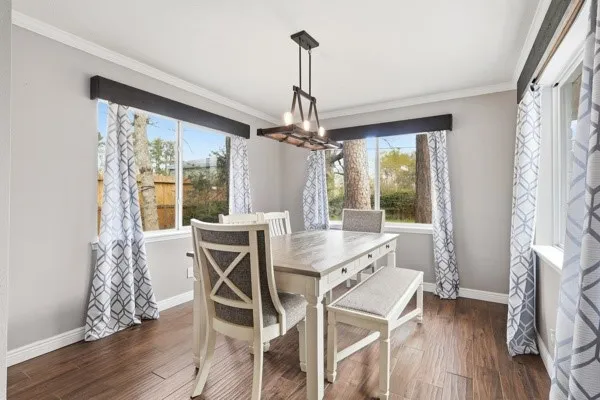 a view of a dining room with furniture window and wooden floor