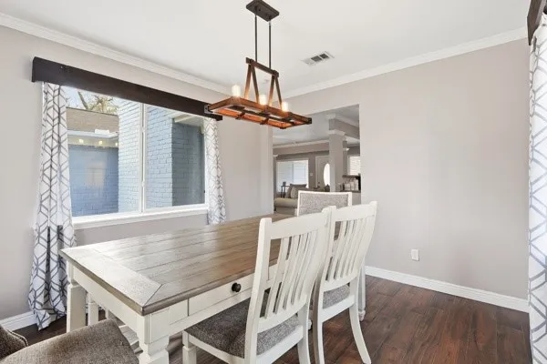 a view of a dining room with furniture and a chandelier