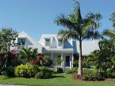 1404 Sand Castle Road Sanibel, FL 33957 - Photo 1 of 10 a front view of house and yard with green space