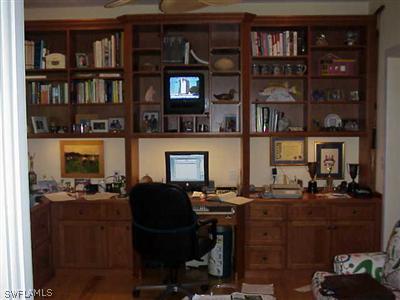 1404 Sand Castle Road Sanibel, FL 33957 - Photo 8 of 10 a view of a workspace with bookshelf