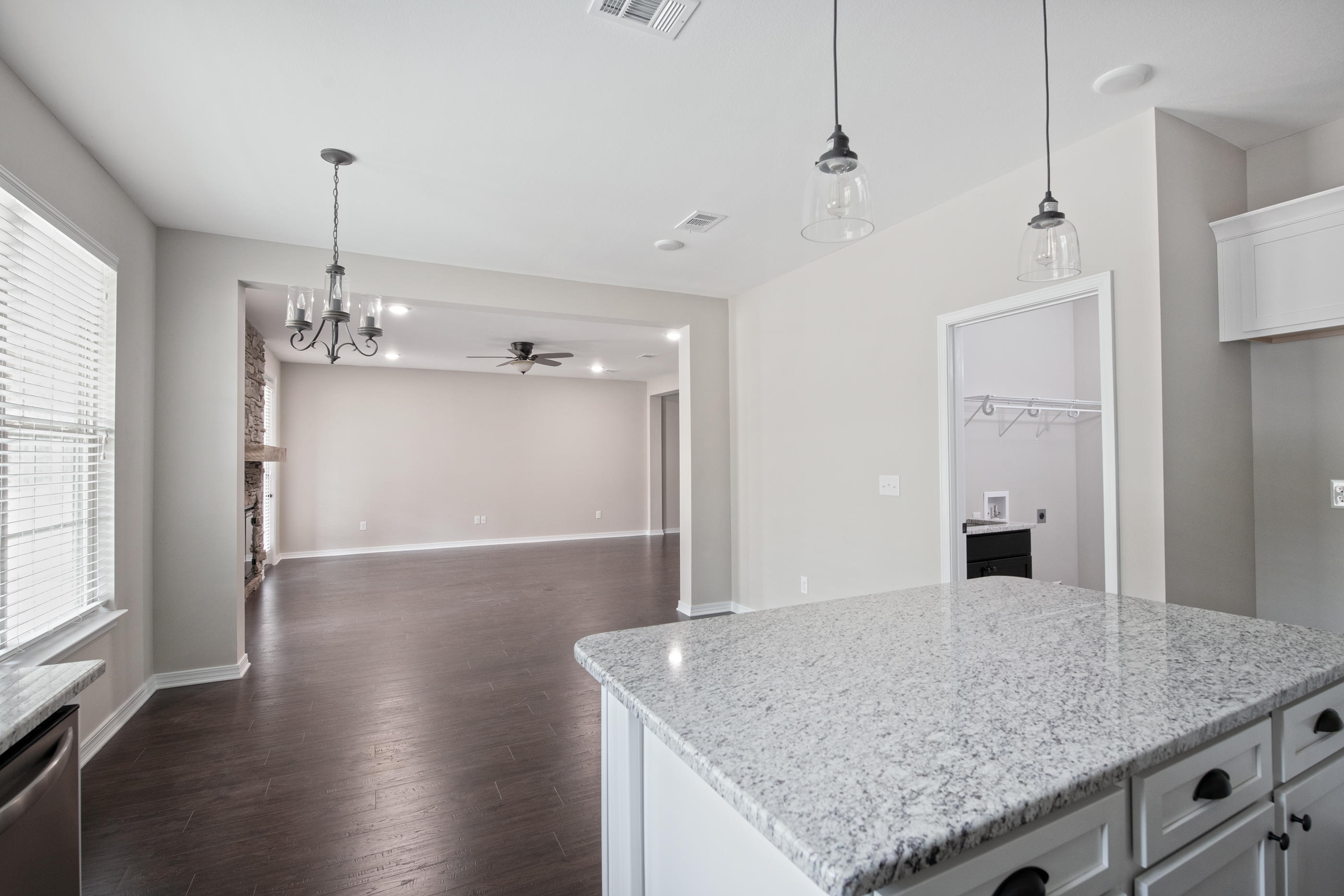 6210 Timberland Ridge Drive Crestview, FL 32539 - Photo 24 of 37 a view of a kitchen island a chandelier and wooden floor