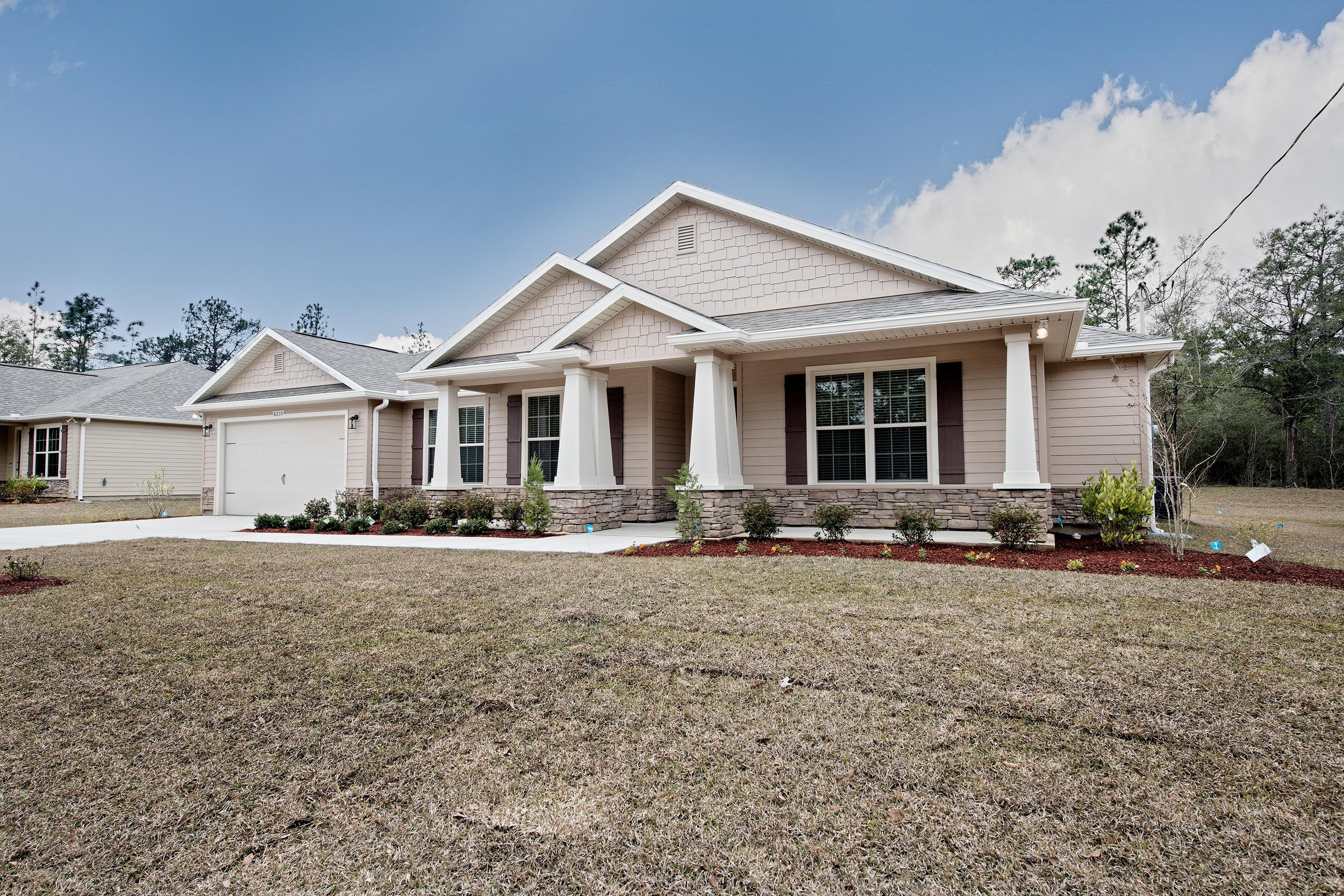 6210 Timberland Ridge Drive Crestview, FL 32539 - Photo 4 of 37 a front view of a house with yard patio and porch