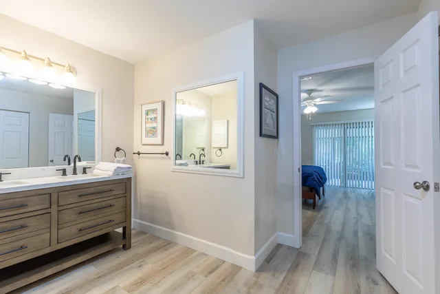 a bathroom with a sink mirror and toilet