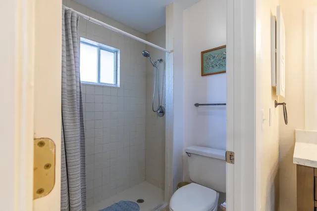 a bathroom with a toilet shower and a sink