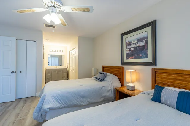 a bedroom with two beds and a chandelier