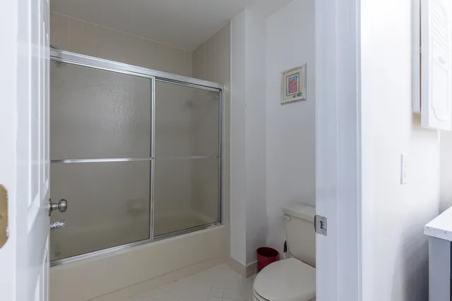 a bathroom with a shower and toilet
