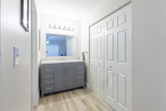 a bathroom with a sink vanity and mirror