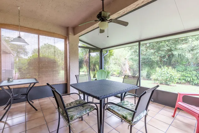 a view of a dining room with furniture large windows and wooden floor