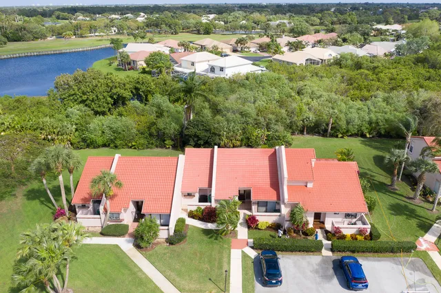 an aerial view of a house with swimming pool and lake view