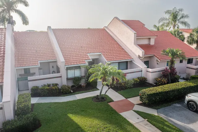 a view of a house with a yard and a garden