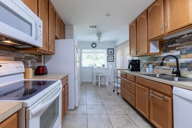 a kitchen with a sink cabinets and window