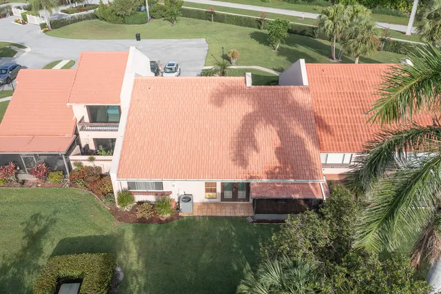 an aerial view of residential houses with outdoor space and trees