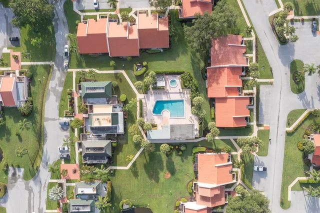 an aerial view of residential houses with outdoor space and street view
