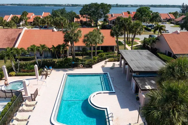swimming pool view with a garden and plants