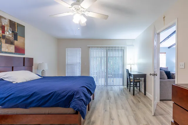 a bedroom with a bed and wooden floor