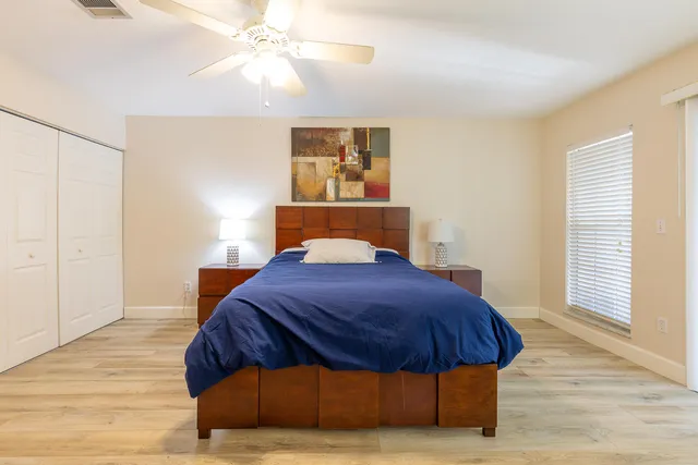 a bedroom with a bed and wooden floor