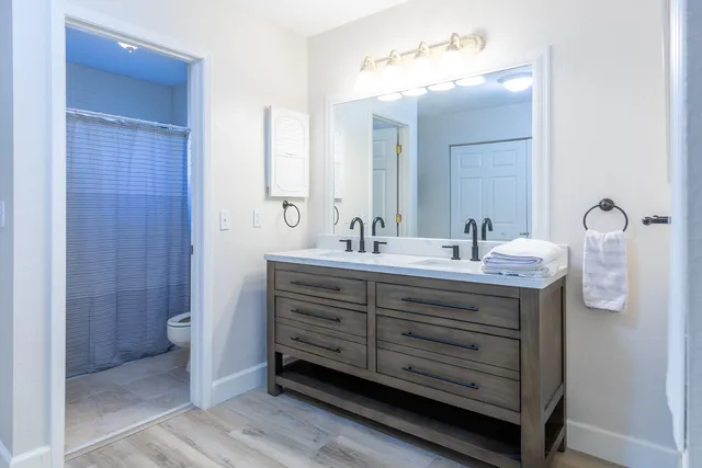 a bathroom with a double vanity sink and mirror
