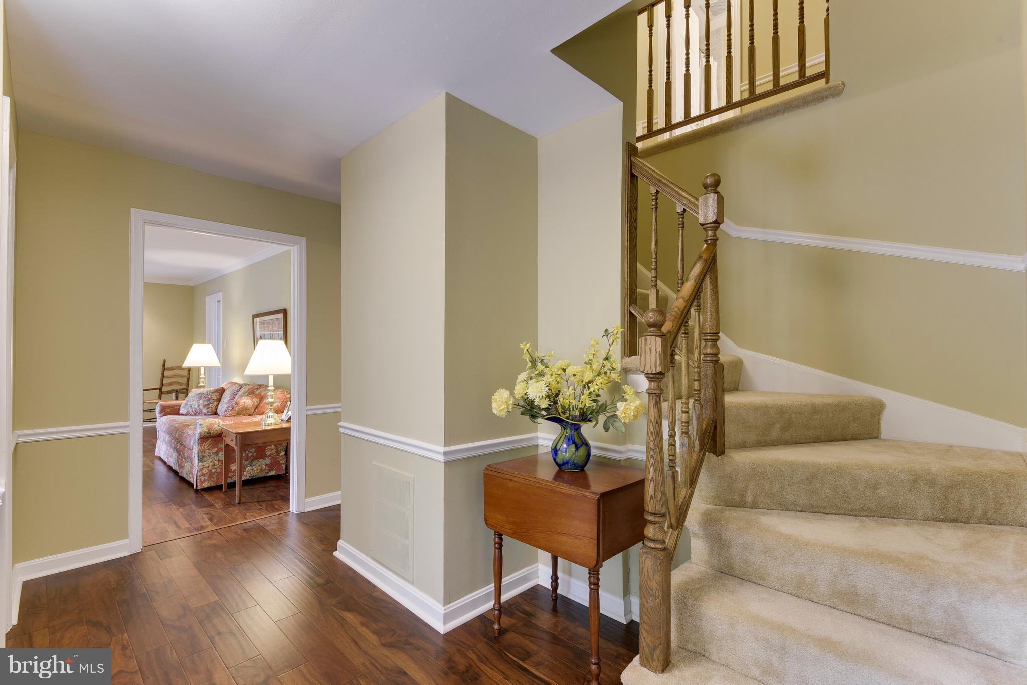 Welcoming Foyer with new hardwoods and fresh paint