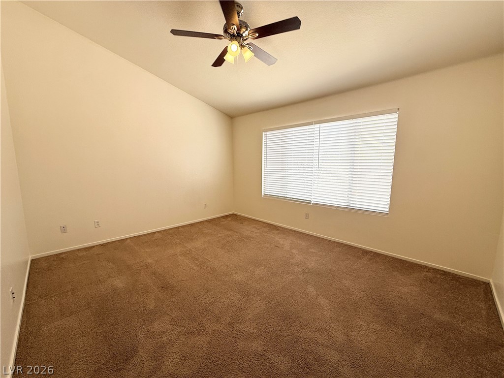 8870 Haviland Road Las Vegas, NV 89123 - Photo 10 of 24 An airy bedroom with plush carpeting and a large window, perfect for quiet repose.