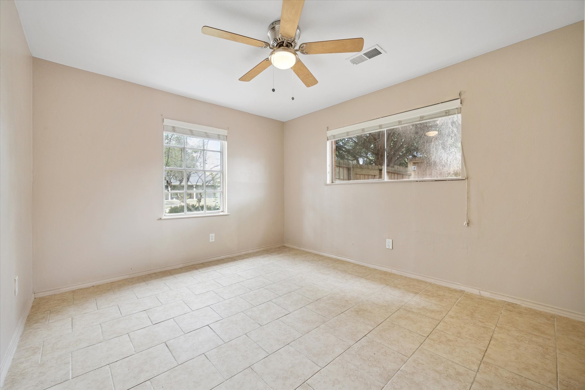 4919 Valkeith Drive Houston, TX 77096 - Photo 20 of 29 an empty room with windows and fan