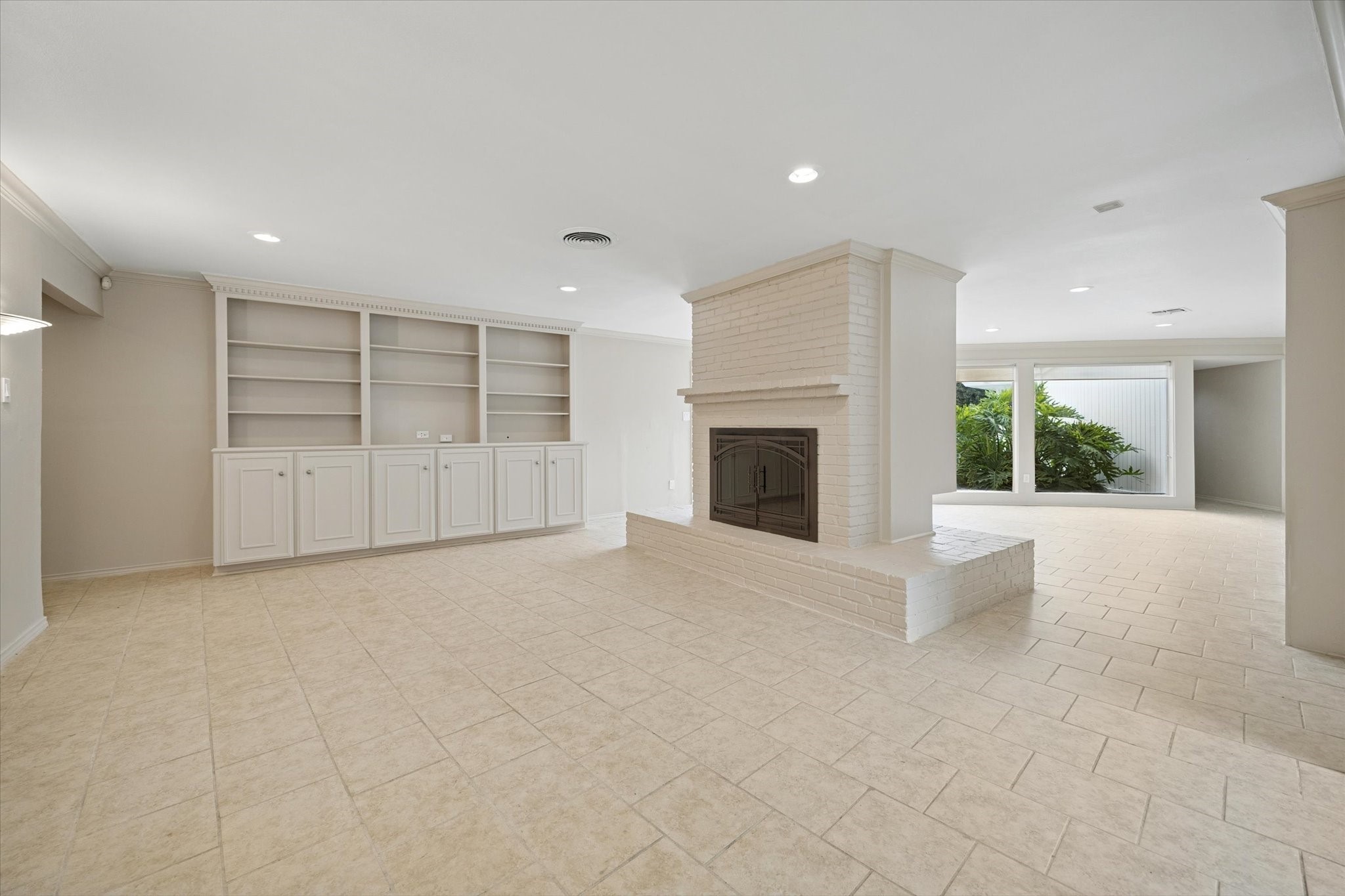4919 Valkeith Drive Houston, TX 77096 - Photo 7 of 29 an empty room with a fireplace and large window