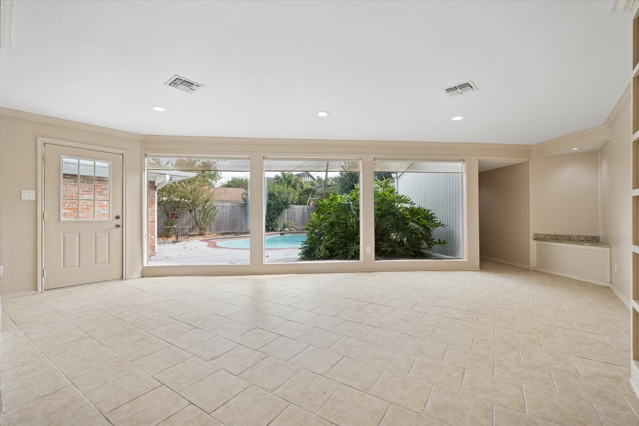 4919 Valkeith Drive Houston, TX 77096 - Photo 9 of 29 a view of an empty room with wooden floor and a window