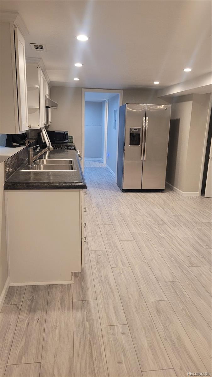 2834 Curtis Street, Unit 3 Denver, CO 80205 - Photo 2 of 22 a view of a refrigerator in kitchen and wooden floor