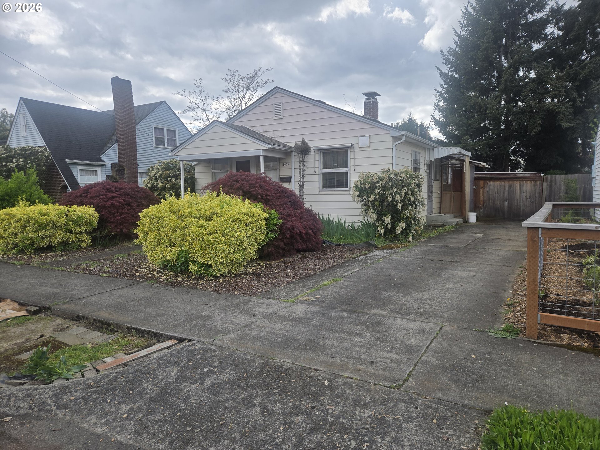 3405 Southeast 69th Avenue Portland, OR 97206 - Photo 1 of 23 a front view of a house with a yard and a garage