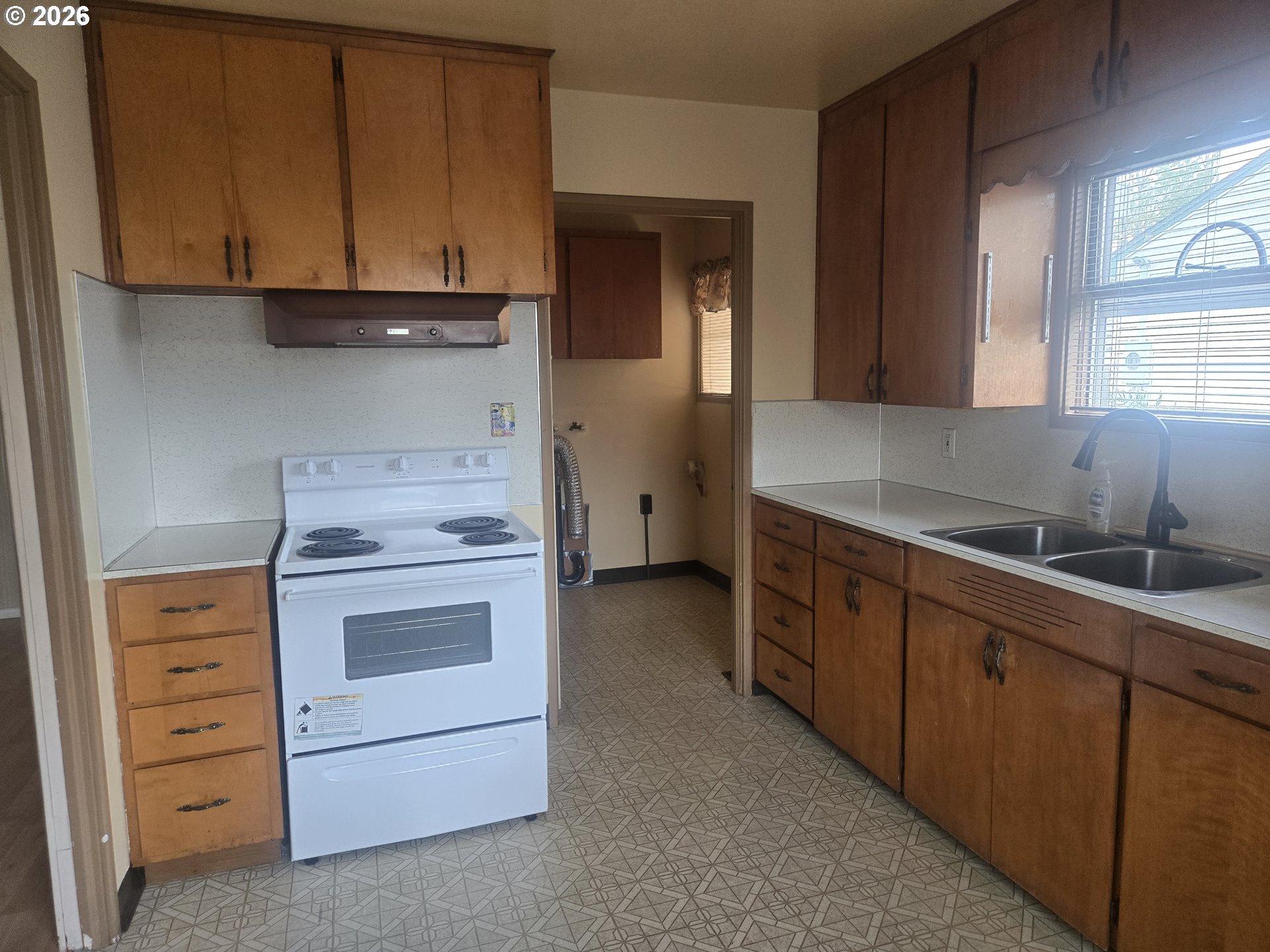 3405 Southeast 69th Avenue Portland, OR 97206 - Photo 11 of 23 a kitchen with cabinets appliances and a window