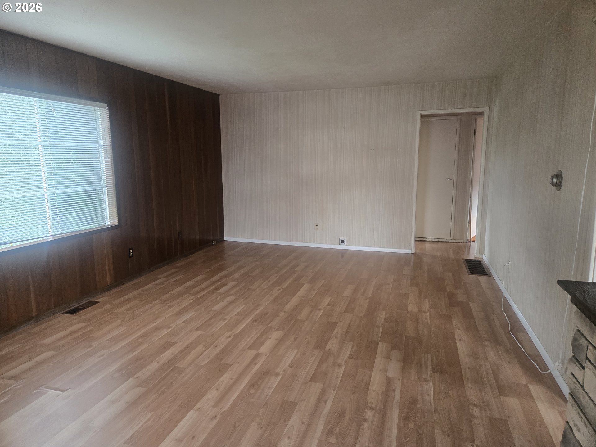 3405 Southeast 69th Avenue Portland, OR 97206 - Photo 4 of 23 a view of an empty room with wooden floor and a window