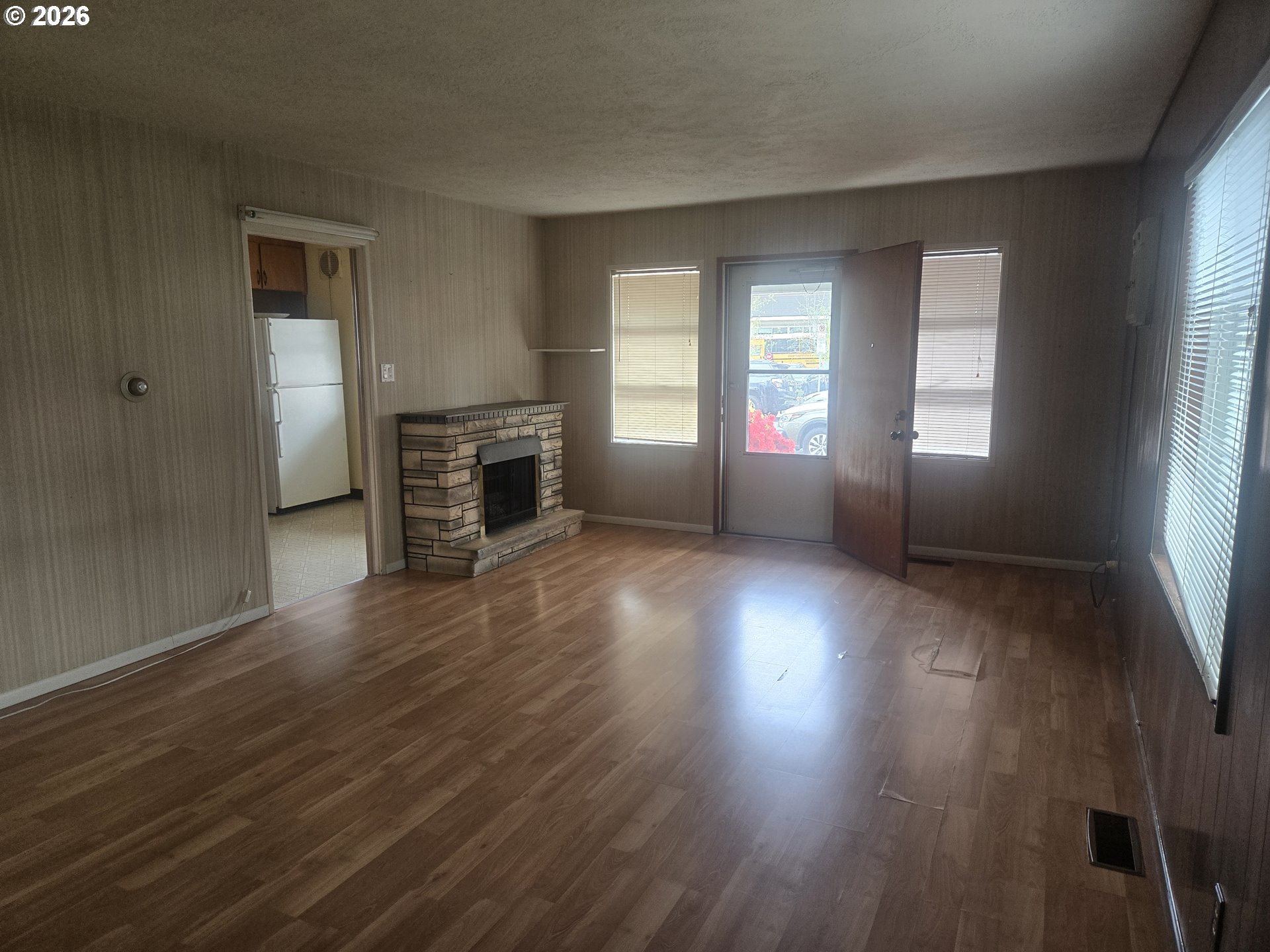 3405 Southeast 69th Avenue Portland, OR 97206 - Photo 6 of 23 an empty room with wooden floor and windows