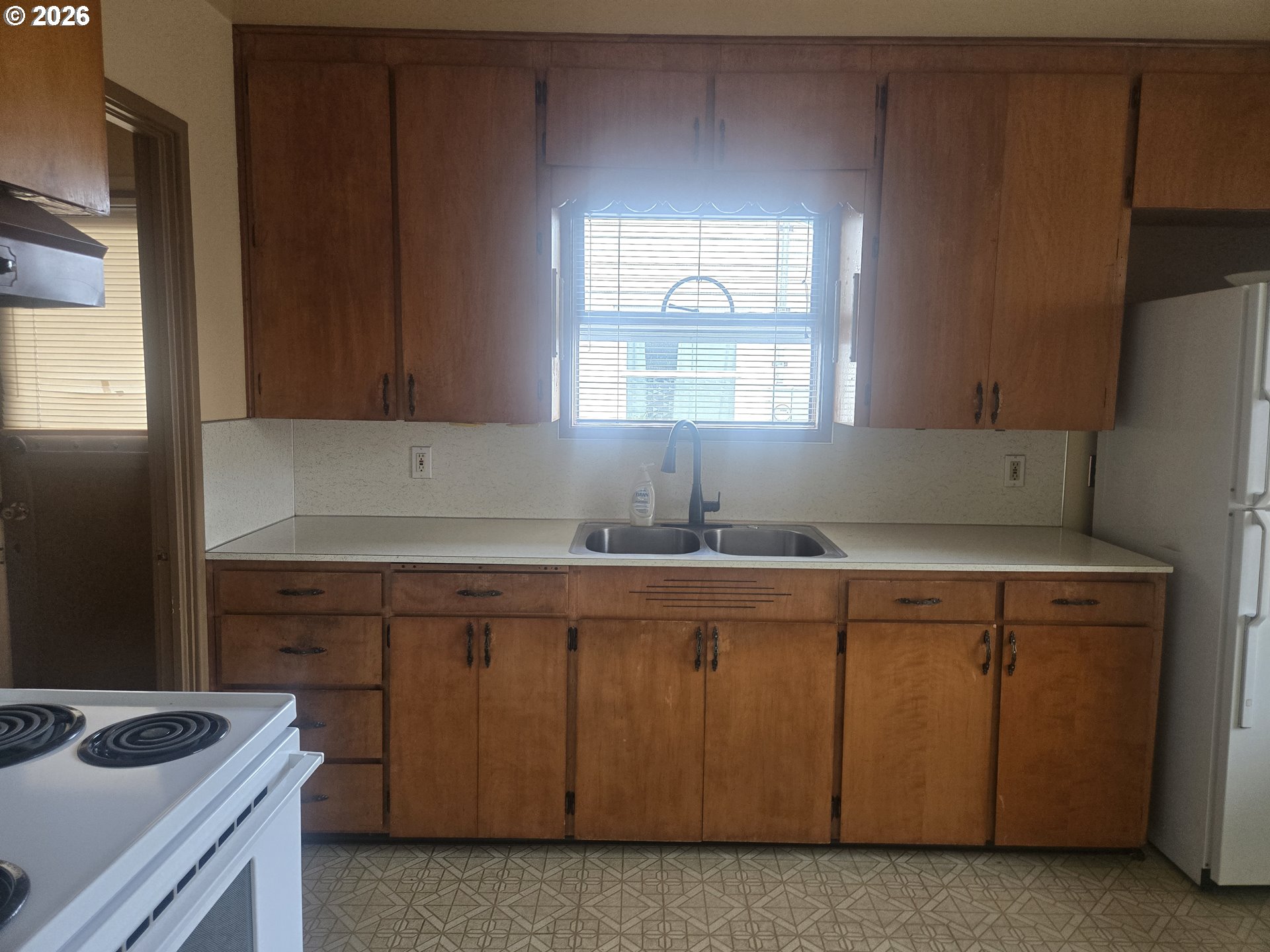 3405 Southeast 69th Avenue Portland, OR 97206 - Photo 7 of 23 a kitchen with a sink cabinets and window