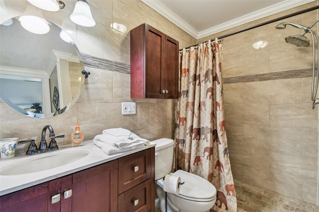 7200 Ulmerton Road, Unit E3 Largo, FL 33771 - Photo 11 of 26 a bathroom with a sink a toilet and shower